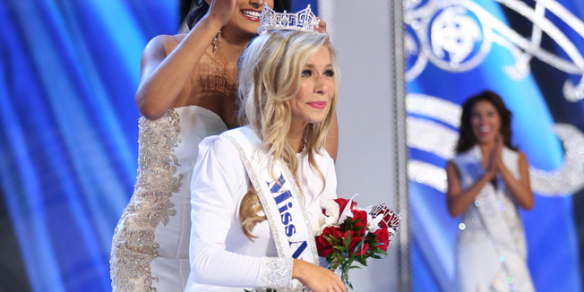 This September 14, 2014 handout photo provided by The Miss America Organization shows Kira Kazantsev, representing New York as she is crowned Miss America 2015 by Miss America 2014 Nina Davuluri at Atlantic City's Boardwalk Hall in Atlantic City, New Jersey. Kazantsev was crowned Miss America late Sunday, the third straight year that the Big Apple's local beauty queen has gone on to win the national pageant. Kazantsev, 22, isn't just a pretty face. She chose protecting women against domestic violence as her advocacy issue and says she's aiming for a master's degree in business administration and a law degree. AFP PHOTO / HANDOUT / The Miss America Organization       == RESTRICTED TO EDITORIAL USE / MANDATORY CREDIT: 