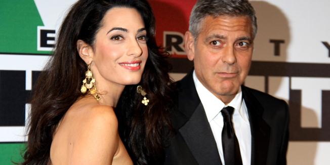 US actor George Clooney arrives with his fiancee Amal Alamuddin at the Celebrity Fight Night to promote the Andrea Bocelli Foundation on September 7, 2014 in Florence.  AFP PHOTO /  STR