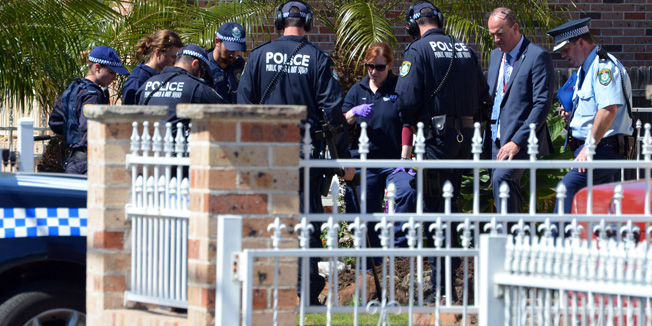 Forensic experts collect evidence from a house in the Guildford area of Sydney on September 18, 2014. Australia's largest ever counter-terrorism raids detained 15 people and disrupted plans to 