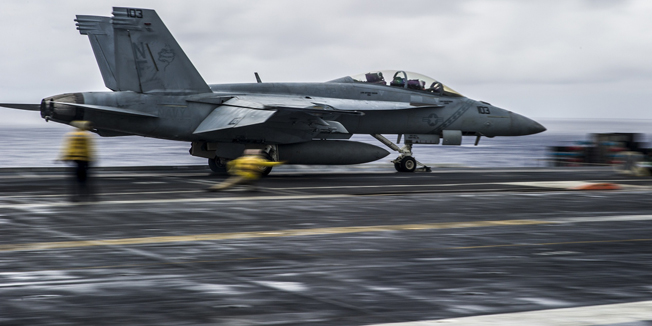 This US Navy photo obtained September 19, 2014 shows an F/A-18F Super Hornet from the Diamondbacks of Strike Fighter Squadron (VFA) 102 as it launches from the flight deck of the US Navy's forward-deployed aircraft carrier USS George Washington (CVN 73) on September 17, 2014 as part of Valiant Shield in the Pacific Ocean. The US-only exercise integrates Navy, Air Force, Army, and Marine Corps assets, offering real-world joint operational experience. AFP PHOTO/US NAVY/Chris Cavagnaro/HANDOUT = RESTRICTED TO EDITORIAL USE - MANDATORY CREDIT 