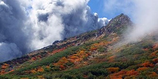 This picture taken by climber Keiji Aoki on September 27, 2014 shows white smoke raising from Mount Ontake as Japan's volcano Ontake erupted in Nagano prefecture, central Japan. A volcano erupted in central Japan, shooting ash and rocks into the air that reportedly left 11 hikers injured, including seven unconscious, and forced 150 people to shelter in cabins near the summit. The eruption of the 3,067-metre Mount Ontake straddling Nagano and Gifu prefecture happened around midday.     AFP PHOTO / JIJI PRESS / KEIJI AOKI    JAPAN OUT