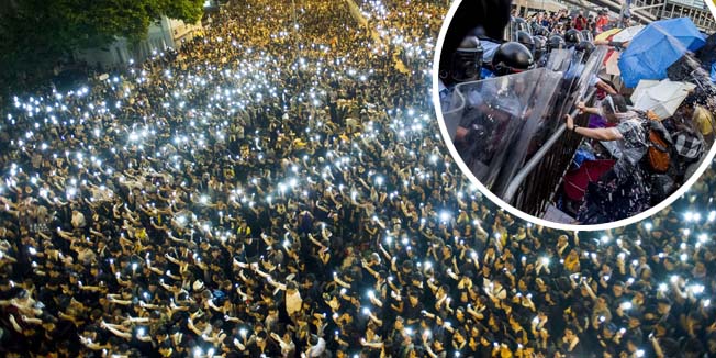 TOPSHOTSProtestors and student demonstrators hold up their cellphones in a display of solidarity during a protest outside the headquarters of Legislative Council in Hong Kong on September 29, 2014. Hong Kong has been plunged into the worst political crisis since its 1997 handover as pro-democracy activists take over the streets following China's refusal to grant citizens full universal suffrage. AFP PHOTO / XAUME OLLEROS
