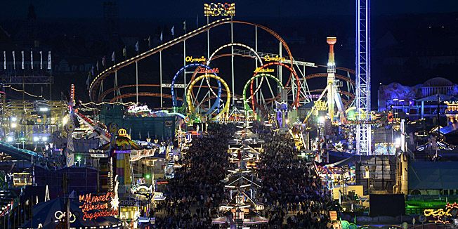 Elevated view shows the traditional Bavarian Oktoberfest Beer festival at the Theresienwiese fair grounds in Munich, southern Germany, in the evening of September 24, 2014. Germany's world-famous Oktoberfest kicks off with millions of revellers set to soak up the frothy atmosphere in a 16-day extravaganza of lederhosen, oompah music and, of course, beer. AFP PHOTO/CHRISTOF STACHE