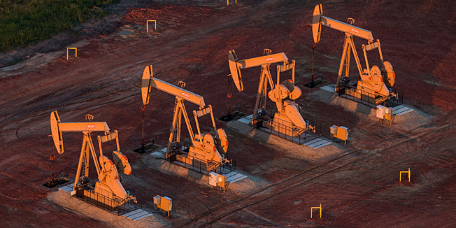 WATFORD CITY, ND - JULY 30: Pumpjacks are seen in an aerial view in the early morning hours of July 30, 2013 near Watford City, North Dakota. North Dakota has seen a boom in oil production thanks to new drilling techniques including horizontal drilling and hydraulic fracturing.   Andrew Burton/Getty Images/AFP== FOR NEWSPAPERS, INTERNET, TELCOS & TELEVISION USE ONLY ==