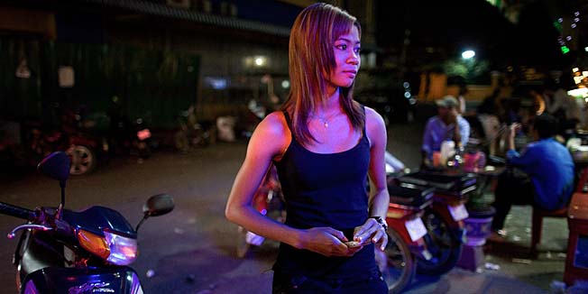 PHNOM PENH, CAMBODIA-FEBRUARY 10 : A bar girl stands outside a local bar waiting for customers February 10, 2010 in Phnom Penh. Lax law enforcement and poverty have made Cambodia a prime destination for foreigners seeking sex, especially with minors. But police working with social activists have stepped up efforts, and several foreigners are serving lengthy prison terms for underage sex.While on a path to greater economic development, poverty is still widespread with 40 percent of the population living under the poverty line according to various UN agencies. (Photo by Paula Bronstein /Getty Images)