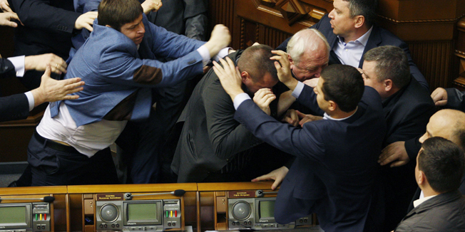 Members of Parliament of the Svoboda party fight with Members of Parliament of the Communist party in the Ukrainian parliament on April 8, 2014, during the debates focused on a law toughening responsibility for separatism. Ukraine's acting president said today he would treat Russian separatists who have seized buildings in the east of the country as 