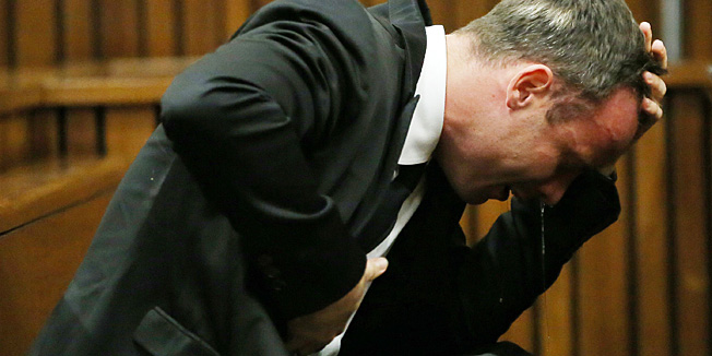 TOPSHOTSSouth African Paralympic track star Oscar Pistorius reacts as he listens to evidence by a pathologist during his trial in court in Pretoria on April 7, 2014. As the defence opens its case, the 27-year-old Paralympian will give the court his first account of why he shot dead his model girlfriend Reeva Steenkamp in the early hours of Valentine's Day in 2013.  AFP PHOTO / POOL / THEMBA HADEBE