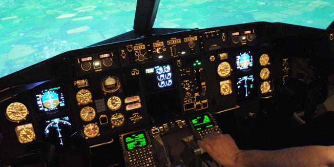 TO GO WITH AFP STORY BY JESSICA LOPEZ ESCURE An employee of the SIM Aviation Group, an aviation training organization, checks various controls aboard a flight simulator for Boeing 767-300ER and 757-200 at a training center in Roissy-en-france, near Roissy airport on April 7, 2014. Rental professionnal flight simulators, which cost between 10 and 15 million euros, are now open to the public for an experience worth 360 euros. AFP PHOTO / ERIC PIERMONT