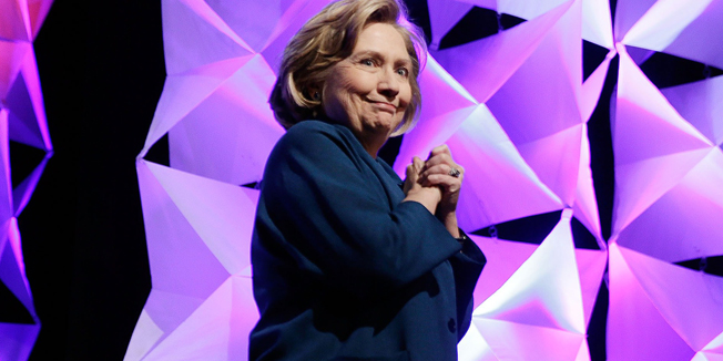 LAS VEGAS, NV - APRIL 10: An agent enters the stage to assist former Secretary of State Hillary Clinton after a woman threw an object toward her while she was delivering remarks at the Institute of Scrap Recycling Industries conference on April 10, 2014 in Las Vegas, Nevada. Clinton is continuing on a speaking tour this week with the stop at the recycling industry trade conference.   Isaac Brekken/Getty Images/AFP== FOR NEWSPAPERS, INTERNET, TELCOS & TELEVISION USE ONLY ==