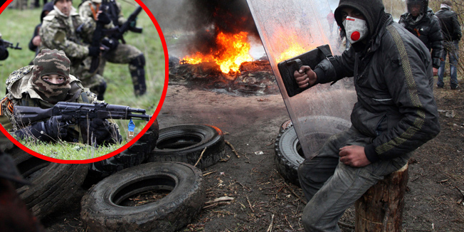 TOPSHOTSPro-Russian protesters burn tires as they prepare for battle with the Berkut (Ukrainian special police forces) on the outskirts of the eastern Ukrainian city of Slavyansk on April 13, 2014. Ukraine's interior minister said on April 13 that both sides had suffered casualties during a raid launched by Ukrainian special forces on a police station in the eastern city of Slavyansk that was seized by pro-Russian gunmen. AFP PHOTO / ANATOLIY STEPANOV
