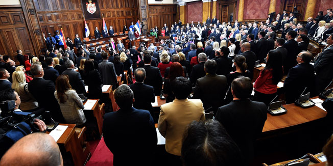 Serbian MP's sing the national anthem at start of the first session of the newly elected parliament in Belgrade on April 16, 2014. Serbia's new parliament, elected on March 16 early polls, was sworn in on Wednesday, paving the way for the new government to lead the Balkan country towards the EU membership. The 250-seat parliament is dominated by the centre-right Serbian Progressive party which has 158 deputies.  AFP PHOTO / ANDREJ ISAKOVIC