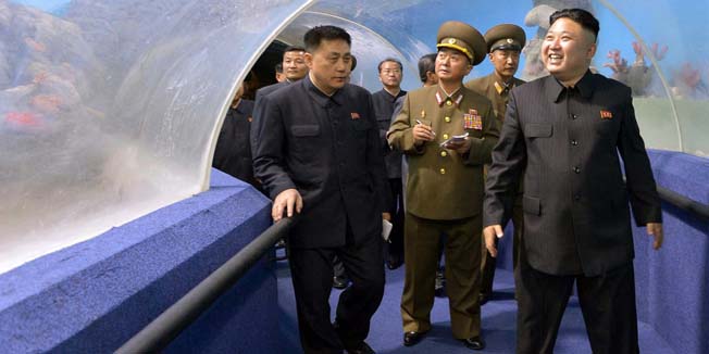 This picture released by North Korea's official Korean Central News Agency (KCNA) on April 21, 2014 shows North Korean leader Kim Jong-Un (R) inspecting an aquarium as he visits the Songdowon international children's camp in Kangwon province in North Korea.  AFP PHOTO / KCNA via KNS    REPUBLIC OF KOREA OUTTHIS PICTURE WAS MADE AVAILABLE BY A THIRD PARTY. AFP CAN NOT INDEPENDENTLY VERIFY THE AUTHENTICITY, LOCATION, DATE AND CONTENT OF THIS IMAGE. THIS PHOTO IS DISTRIBUTED EXACTLY AS RECEIVED BY AFP.---EDITORS NOTE--- RESTRICTED TO EDITORIAL USE - MANDATORY CREDIT 
