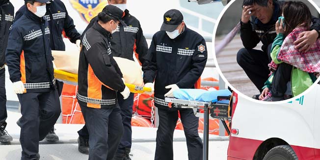 South Korean rescue members carry the body of a victim recovered from the 