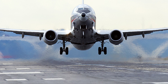 (FILES)An American Airlines Boeing 737 airplane takes off from a runway at Ronald Reagan Washington National Airport in Arlington, Virginia, in this September 23, 2013 file photo.   US aerospace and defense giant Boeing raised its 2014 profit outlook on April 23, 2014 despite a first-quarter profit slide, citing strong demand for its new jetliners. A sharp rise in pension costs from a change in retirement plans offset Boeing's robust commercial aircraft deliveries as airlines seek to renew aging fleets with more fuel-efficient jetliners. AFP PHOTO / Saul LOEB