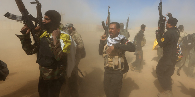 TOPSHOTSIraqi fighters of the government-controlled Popular Mobilisation units take part in a military operation to take control of Tikrit, 160 kms north of Baghdad,  from jihadists from the Islamic state (IS) group, on March 11 2015.  The city, which is the home town of former president Saddam Hussein, is the toughest target for the government troops and allied militias that started winning back lost ground last year. AFP PHOTO / AHMAD AL-RUBAYE