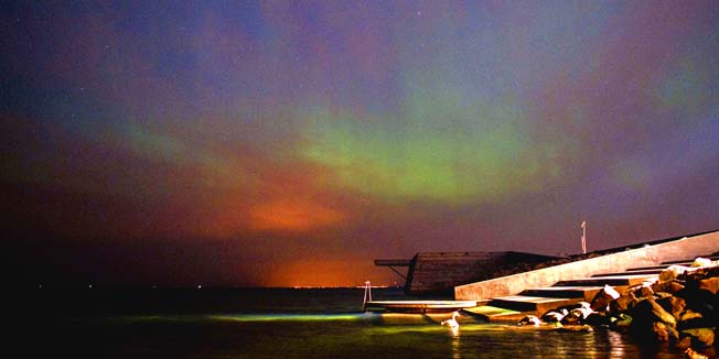 The aurora borealis, or the northern lights phenomenon is seen on the sky over Oresund, the strait that separates Denmark and Sweden, seen from Malmo, southern Sweden, early on March 18, 2015. AFP PHOTO / TT NEWS AGENCY / Johan Nilsson +++SWEDEN OUT
