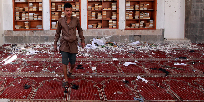 A Yemeni man inspects the damage following a bomb explosion at the Badr mosque in southern Sanaa on March 20, 2015. Triple suicide bombings killed at least 55 people at mosques in the Yemeni capital attended by Shiite Huthi militiamen who have seized control of the city. AFP PHOTO / MOHAMMED HUWAIS