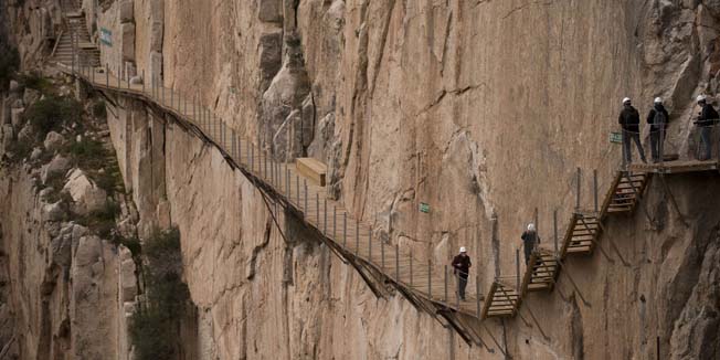 Journalists walk during a visit to the foot-path 