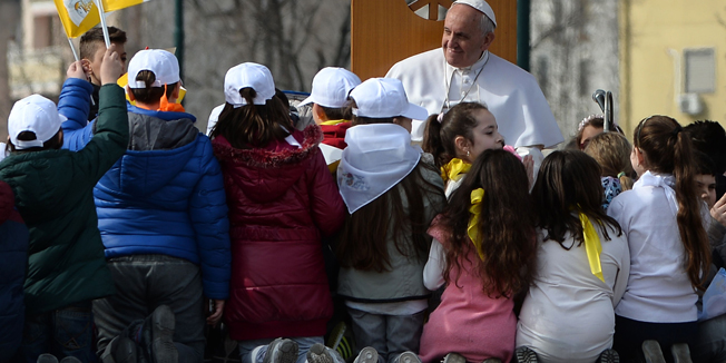 Children gather around Pope Francis during a pastoral visit in the Scampia district on March 21, 2015 in Naples. Up to 800,000 people are expected to gather in the southern Italian city to welcome the Argentine pontiff, who declared war on organised crime last year by 