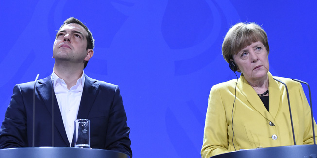 German Chancellor Angela Merkel (R) and Greek Prime Minister Alexis Tsipras address a press conference following talks at the chancellery in Berlin, on March 23, 2015. AFP PHOTO / TOBIAS SCHWARZ