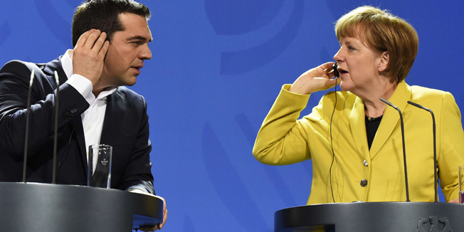 German Chancellor Angela Merkel (R) and Greek Prime Minister Alexis Tsipras hold their earpieces as they address a press conference following talks at the chancellery in Berlin, on March 23, 2015. AFP PHOTO / TOBIAS SCHWARZ