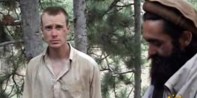 (FILES) In this filed still image provided by IntelCenter on December 7, 2010 shows the Taliban associated video production group Manba al-Jihad December 7, 2010 release of someone that appears to be US soldier Bowe Bergdahl (L), who has been held hostage by the Taliban since his disappearance from his unit on June 30, 2009.  The US soldier who was held by insurgents for five years after disappearing from his post in Afghanistan, Sergeant Bowe Bergdahl, has been charged with desertion and 