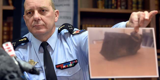 French General David Galtier holds up a picture of the second black box from the Germanwings plane that crashed in the French Alps last week during a press conference in Marseille, southern France, on April 2, 2015. The co-pilot suspected of deliberately crashing an airliner in the French Alps searched online for information about suicide and cockpit doors, prosecutors said on April 2, as it emerged the plane's second black box had been found in 
