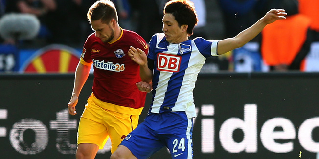BERLIN, GERMANY - APRIL 05:  Genki Haraguchi of Berlin (R) battles for the ball with Michael Heinloth of Paderborn during the Bundesliga match between Hertha BSC and SC Paderborn 07 at Olympiastadion on April 5, 2015 in Berlin, Germany.  (Photo by Martin Rose/Bongarts/Getty Images)