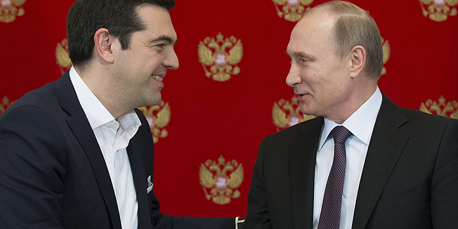 Greek Prime Minister Alexis Tsipras (L) shakes hands with Russian President Vladimir Putin during a signing ceremony at the Kremlin in Moscow on April 8, 2015. AFP PHOTO / POOL / ALEXANDER ZEMLIANICHENKO