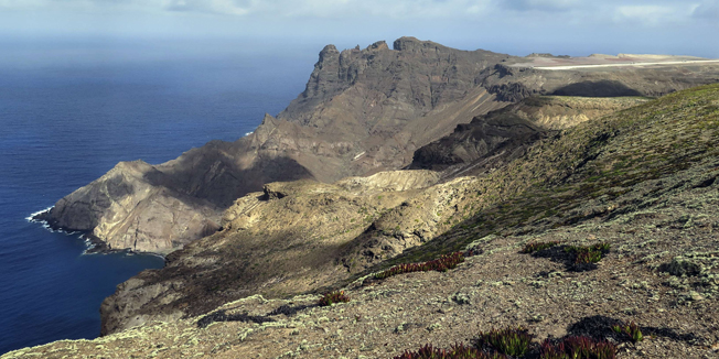 TO GO WITH AFP STORY BY JEAN LIOUView taken on March 15, 2015 shows the edge of the runway of the future airport of the island of Saint Helena currently under construction in Jamestown.  Saint Helena's major claim to fame is as the place where the fallen French emperor Napoleon died in exile, but now the destiny of the tiny island is about to change with the opening of its first airport next year. AFP PHOTO / JEAN LIOU