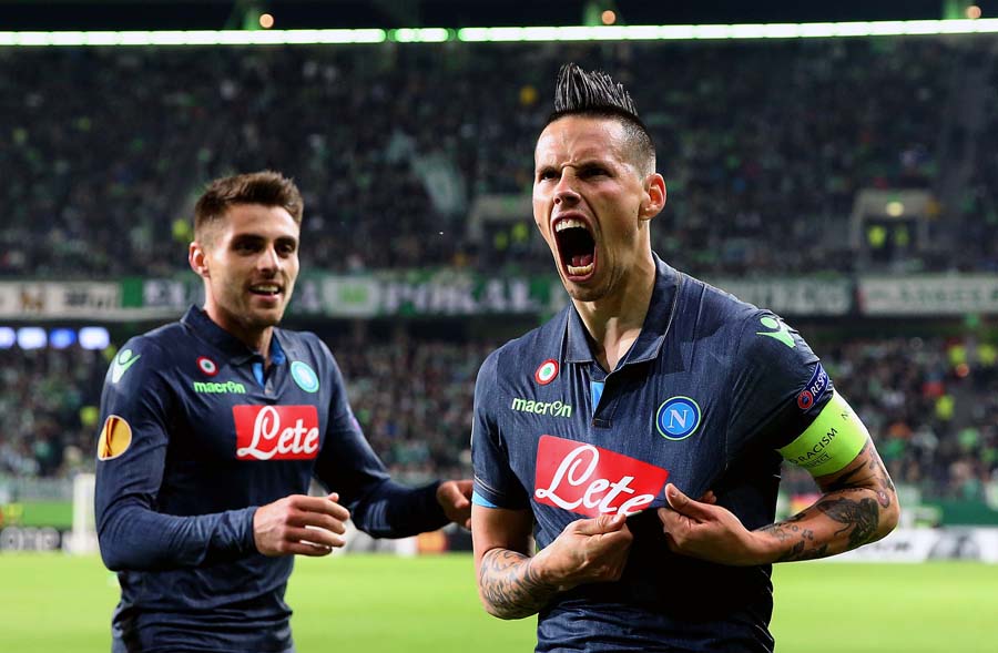 Napoli's Slovakian midfielder Marek Hamsik (R) celebrates after scoring his team's second goal with his team-mates during the UEFA Europa League first-leg quarter-final football match VfL Wolfsburg v SSC Napoli in Wolfsburg on April 16, 2015. AFP PHOTO / RONNY HARTMANN                 ALTERNATIVE CROP