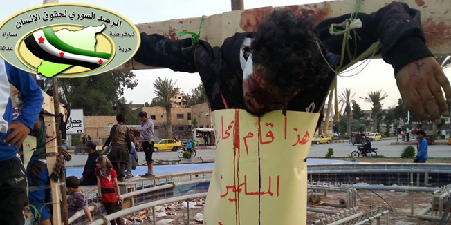 ==GRAPHIC CONTENT===A handout picture released by the Syrian Observatory for Human Rights (SOHR) on April 29, 2014 shows the bodies of two men who were allegedly executed and then crucified by fighters from the al-Qaeda-linked group, Islamic State of Iraq and the Levant (ISIL) in the northern Syrian city of Raqqa. The banner around the body reads in Arabic: 