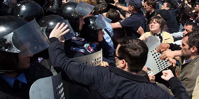 Pro-Russian activists attack policemen guarding the burned trade union building in the southern Ukrainian city of Odessa on May 3, 2014. More than 30 people were killed in a 