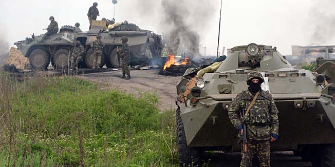 TOPSHOTSUkrainian soldiers stand at a checkpoint they seized in the early morning in the village of Andreevka, 7 km from the center of the southern Ukrainian city of Slavyansk, on May 2, 2014. Ukraine's military lost two helicopters and two servicemen on May 2 in a deadly offensive launched just before dawn against pro-Russian rebels holding the flashpoint town of Slavyansk, insurgents and authorities said. AFP PHOTO / VASILY MAXIMOV
