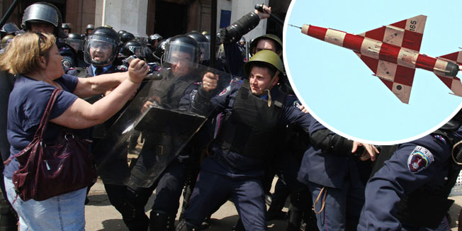 Pro-Russian activists attack policemen guarding the burned trade union building in the southern Ukrainian city of Odessa on May 3, 2014. More than 30 people were killed in a 