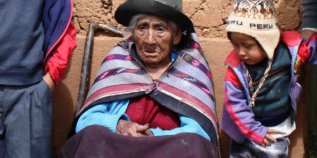 Handout picture distributed in Lima by the Peruvian Ministry of Development and Social Inclusion of  116-year-old Filomena Taipe Mendoza (C), reportedly born on December 20, 1897, surrounded by members of her family outside her modest home on April 30, 2014 in Huancavelica, 440 km east of Lima. Taipe heads the list of 400 senior Peruvians over 100 years old that were incorporated as pensioners in a social program for elderly people living in extreme poverty. Taipe has been quoted by the ministry's communications office as saying: 