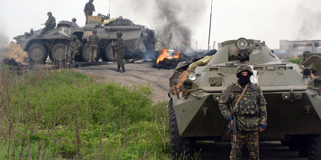 TOPSHOTSUkrainian soldiers stand at a checkpoint they seized in the early morning in the village of Andreevka, 7 km from the center of the southern Ukrainian city of Slavyansk, on May 2, 2014. Ukraine's military lost two helicopters and two servicemen on May 2 in a deadly offensive launched just before dawn against pro-Russian rebels holding the flashpoint town of Slavyansk, insurgents and authorities said. AFP PHOTO / VASILY MAXIMOV