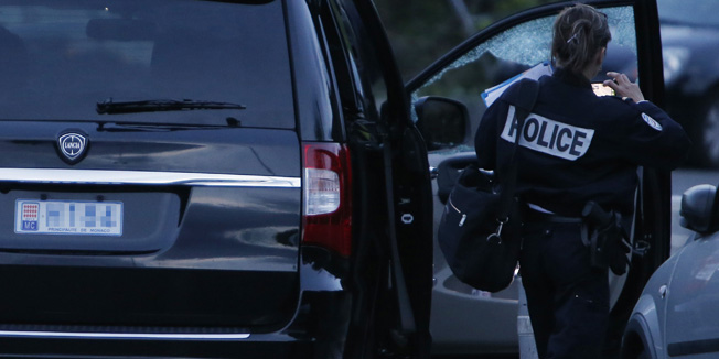 A police officer investigates a car at the site of a shooting which injured Helene Pastor, sister of late Monegasque businessman Michel Pastor, and her driver earlier in the evening on May 6, 2014, outside The Archet hospital in Nice, southeastern France. A third person was injured and police said several people fled the scene.  AFP PHOTO /  VALERY HACHE