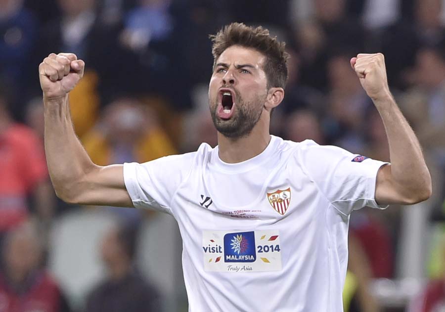 Sevilla's defender Coke celebrates after scoring a penalty during the penalty shoot out during the UEFA Europa league final football match between Benfica and Sevilla on May 14, 2014 at the Juventus stadium in Turin.    AFP PHOTO / MARCO BERTORELLO
