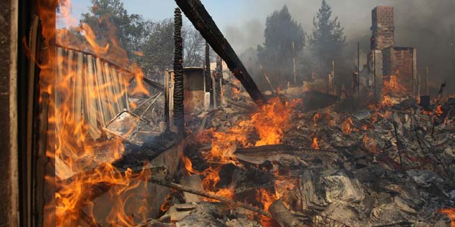 SAN MARCOS, CA - MAY 15: A house burns at the Cocos fire on May 15, 2014 in San Marcos, California. Fire agencies throughout the state are scrambling to prepare for what is expected to be a dangerous year of wildfires in this third year of extreme drought in California.   David McNew/Getty Images/AFP== FOR NEWSPAPERS, INTERNET, TELCOS & TELEVISION USE ONLY ==