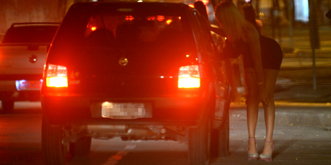 TO GO WITH AFP STORYProstitutes and tranvestites wait for clients in the streets of Belo Horizonte, Minas Gerais State, Brazil, on April 25, 2013. Sex workers in Brazil's city of Belo Horizonte, which will host matches of the upcoming Confederations Cup and the 2014 World Cup, including semi-finals of both football tournaments, are being offered free English lessons to help them welcome the tourist onslaught. More than 300 prostitutes have already signed up for the free classes offered by the Sex Workers' Association in Minas Gerais state, though currently only 20 are actually attending classes.   AFP PHOTO /VANDERLEI ALMEIDA