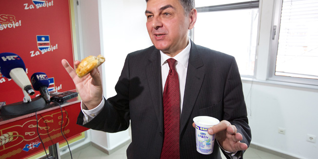 Osijek, 170514.Izvanredna konferencija za medije Vladimira Sisljagica predsjednika HDSSB-a zbog Istrage USKOK-a zbog zlouporabe polozaja i ovlasti.Na konferenciju je doneseno desetak bureka sa sirom zbog danasnjeg teksta u Jutarnjem listu.Na fotografiji: Vladimir Sisljagic pojeo je jedan burek koji je donesen na konferenciju za medijeFoto: Vlado Kos / Cropix