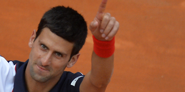 Novak Djokovic of Serbia celebrates after winning the ATP Rome's Tennis Masters final against Rafael Nadal of Spain on May 18, 2014, at the Foro Italico in Rome. Djokovic won 4-6, 6-3, 6-3.   AFP PHOTO / ANDREAS SOLARO