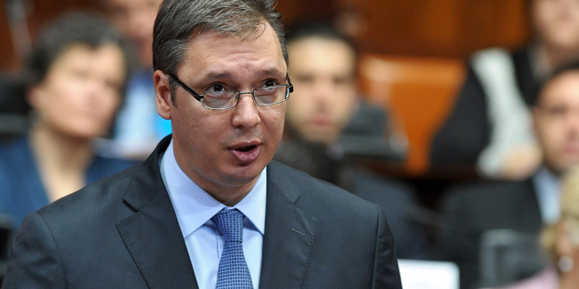 Deputy Prime Minister Aleksandar Vucic (C) and leader of the ruling Serbian Progressive Party (SNS) speaks during a parliamentary session at the Serbian National assembly in Belgrade on April 27, 2014.  AFP PHOTO / ALEXA STANKOVIC