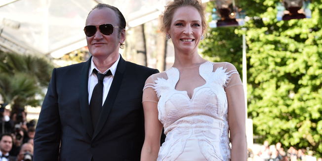 US director Quentin Tarantino (L) and US actress Uma Thurman pose as they arrive for the Closing Ceremony of the 67th edition of the Cannes Film Festival in Cannes, southern France, on May 24, 2014.     AFP PHOTO / BERTRAND LANGLOIS
