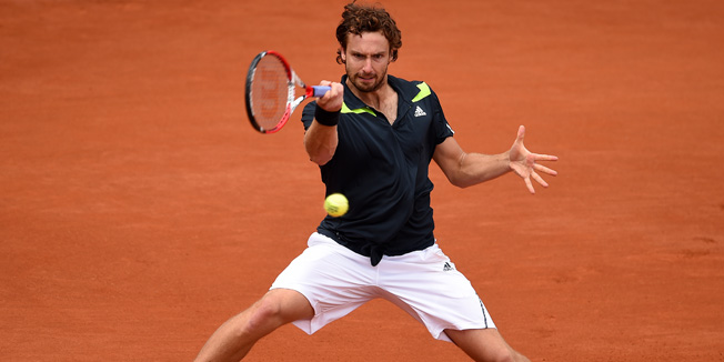 PARIS, FRANCE - MAY 30:  Ernests Gulbis of Latvia returns a shot during his men's singles match against Radek Stepanek of Czech Republic on day six of the French Open at Roland Garros on May 30, 2014 in Paris, France.  (Photo by Matthias Hangst/Getty Images)