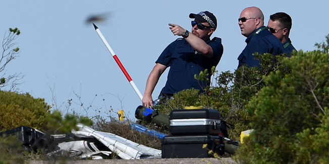 Police investigating the disappearance of British girl Madeleine McCann work in Praia da Luz, near Lagos on June 2, 2014 searching the area of scrubland near the holiday apartment in Portugal where she vanished seven years ago. The joint Portuguese-British operation could last up to a week, and take in three different patches of land, according to Portuguese media reports.  AFP FRANCISCO LEONG