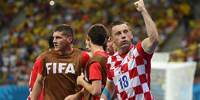 Croatia's forward Ivica Olic (R) celebrates after unseen teammate and midfielder Ivan Perisic scored their second goal during the Group A football match between Cameroon and Croatia at The Amazonia Arena in Manaus on June 18, 2014, during the 2014 FIFA World Cup.    AFP PHOTO / JAVIER SORIANO