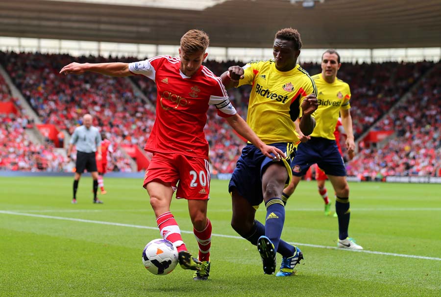 SOUTHAMPTON, ENGLAND - AUGUST 24:  Adam Lallana of Southampton is tackled by Modibo Diakite of Sunderland during the Barclays Premier League match between Southampton and Sunderland at St Mary's Stadium on August 24, 2013 in Southampton, England.  (Photo by Clive Rose/Getty Images)
