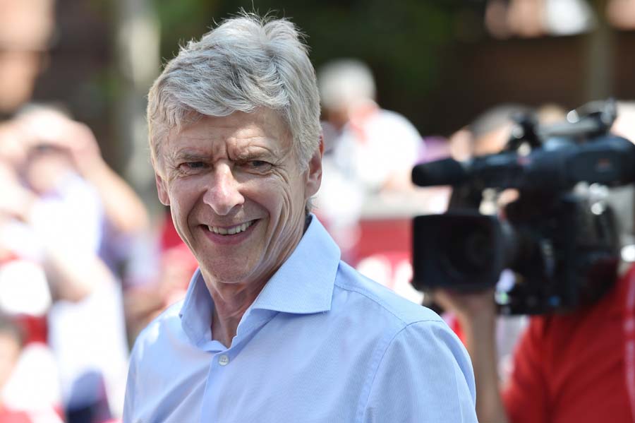 Arsenal's French manager Arsene Wenger smiles durin g their victory parade in London on May 18, 2014, following their win in the English FA Cup final football match on May 17, 2014 against Hull City.  Aaron Ramsey insists Arsenal's dramatic FA Cup final victory will be the springboard for more glory now the Gunners have finally ended their trophy drought. Ramsey scored the extra-time goal that clinched a 3-2 win over Hull in Saturday's clash at Wembley, putting silverware back in the Arsenal trophy cabinet for the first time since 2005.  AFP PHOTO /  LEON NEAL